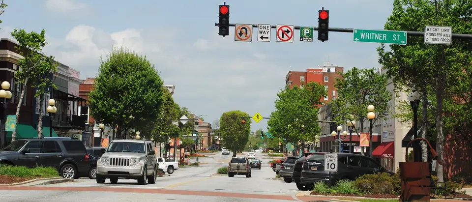 Main Street in downtown Anderson, SC, with shops, street trees and traffic lights