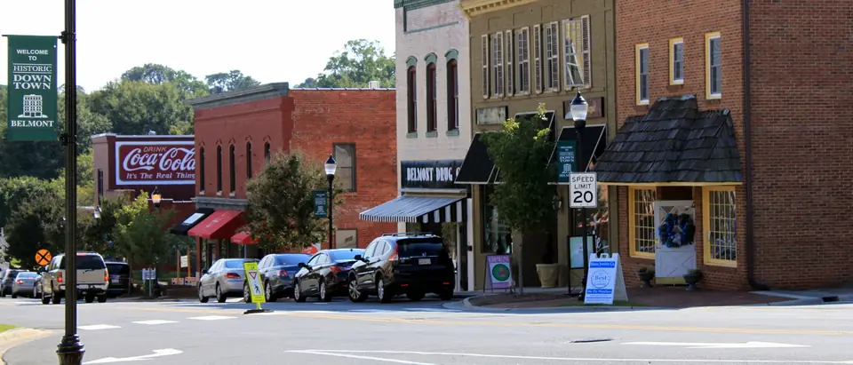 Historic brick storefronts on Main Street in downtown Belmont, NC, on a sunny day