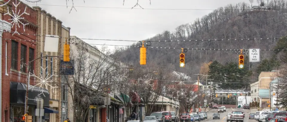 King Street in downtown Boone, NC, with shops and a wooded mountain behind