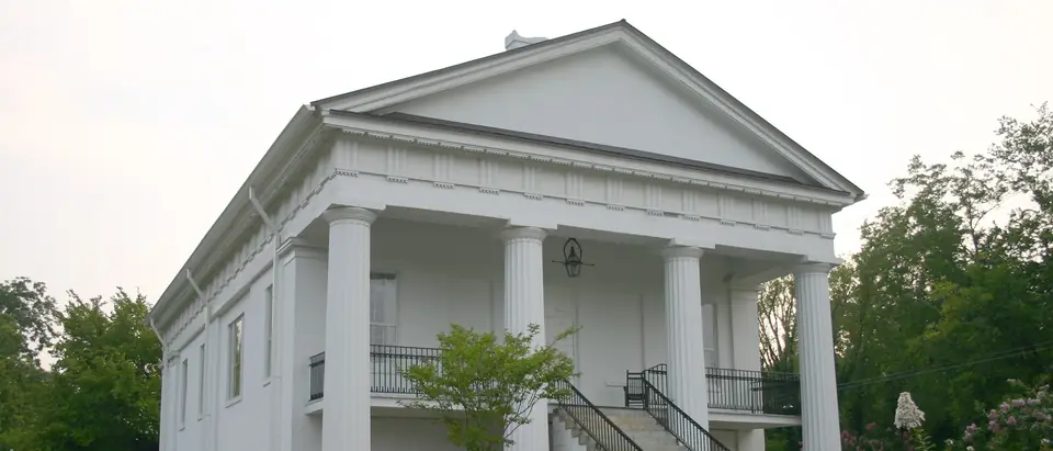 The white-columned 1826 Kershaw County Courthouse behind an iron fence in Camden, SC