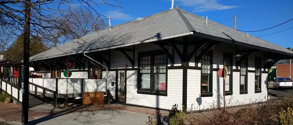 The Station, Carrboro's historic railway depot, under a blue sky in Carrboro, NC
