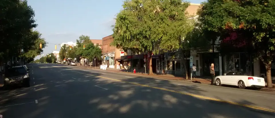 Franklin Street in downtown Chapel Hill, NC, lined with shade trees and storefronts