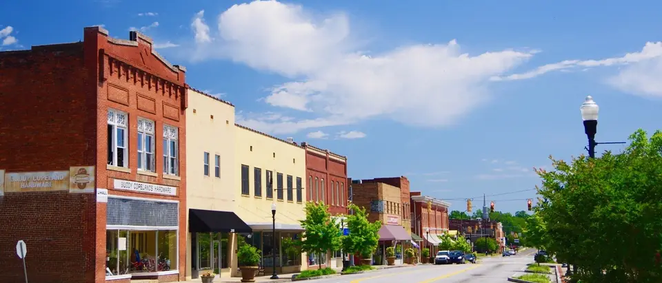A row of historic brick storefronts along Broad Street in downtown Clinton, SC