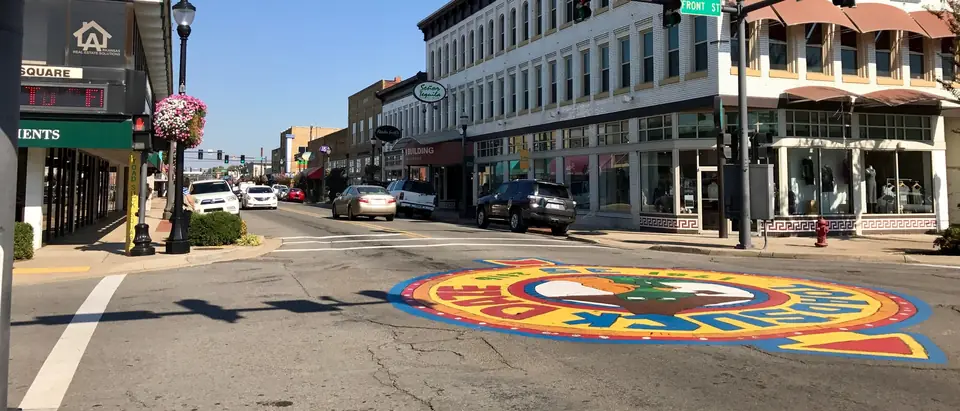 Main Street in downtown Conway, SC, with a painted crosswalk, historic storefronts and blue sky