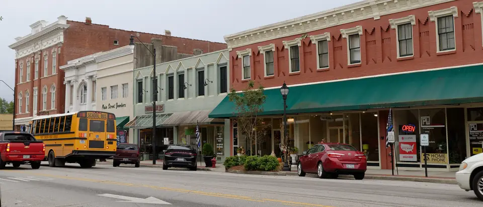 Historic two-storey storefronts with green awnings on the town square in downtown Darlington, SC