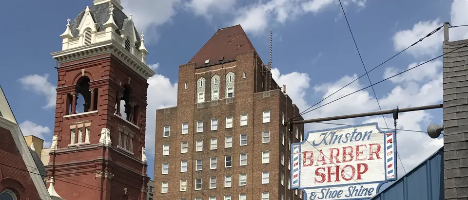 Queen Street United Methodist Church and the tall Kinston Hotel on Queen Street in downtown Kinston, NC