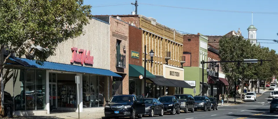 Main Street in downtown Lexington, NC, with shopfronts, awnings and a church steeple