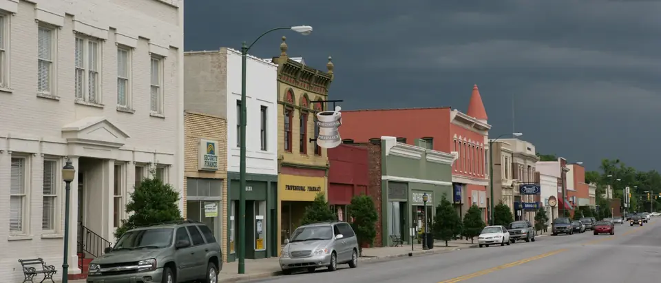 Main Street in downtown Marion, SC, lined with historic storefronts under a stormy sky