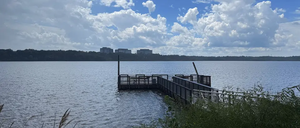 A fishing pier on Lake Crabtree under a blue summer sky in Morrisville, NC