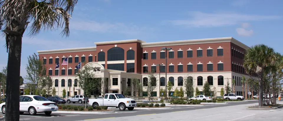 North Charleston City Hall, a red-brick office building framed by palm trees, in North Charleston, SC