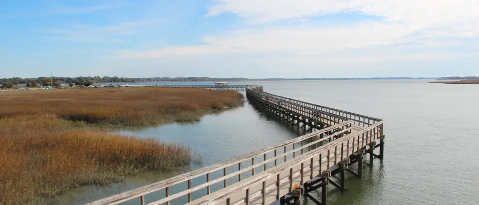 The wooden boardwalk over the marsh and water at the Sands beach in Port Royal, SC
