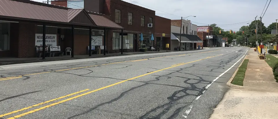 Main Street through downtown Randleman, NC, with a row of brick storefronts