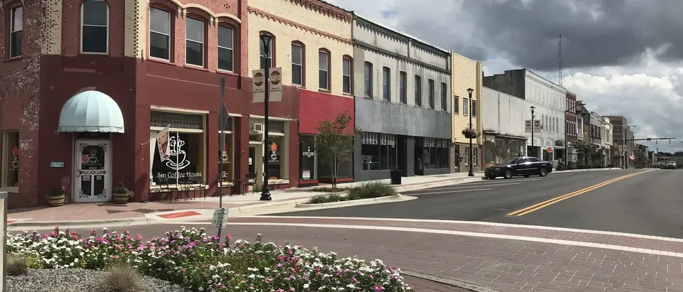 South Scales Street in downtown Reidsville, NC, with flower beds and historic brick storefronts