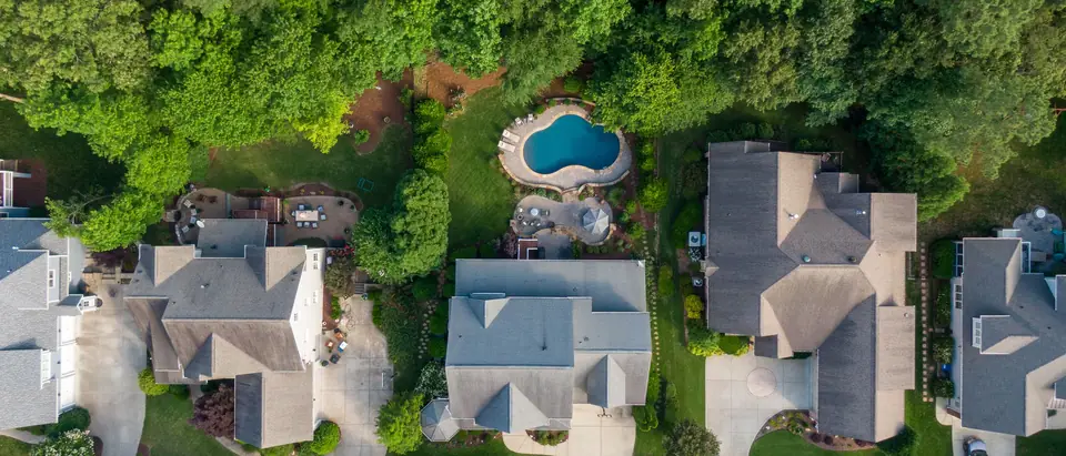 Rooftops, gardens and a pool in a leafy neighbourhood of Wake Forest, NC, next door to Rolesville, seen from above