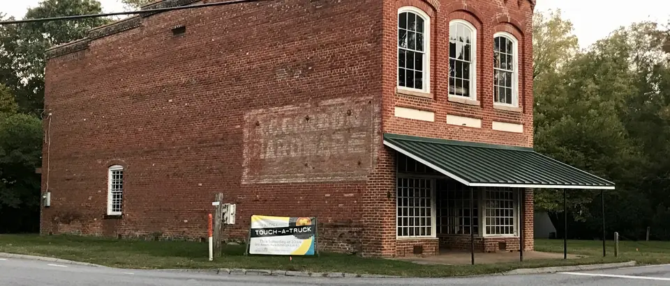 The old red-brick hardware store at the crossroads of the Summerfield Historic District in Summerfield, NC