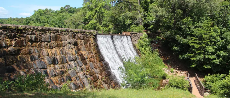 Water spilling over the old stone Lake Placid dam at Paris Mountain State Park, a short drive from Taylors, SC