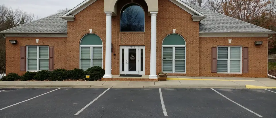 The brick Tega Cay City Hall with its white columns and arched window in Tega Cay, SC