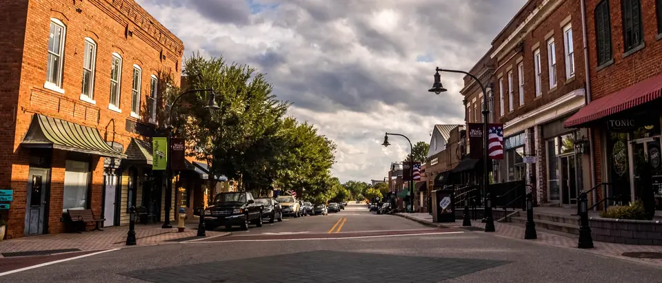 South White Street in downtown Wake Forest, NC, with historic brick storefronts and street lamps