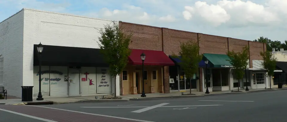 A block of brick storefronts with awnings along North Main Street in downtown Wendell, NC