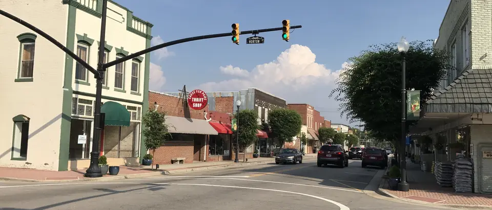 Arendell Avenue in downtown Zebulon, NC, with historic storefronts under a blue sky